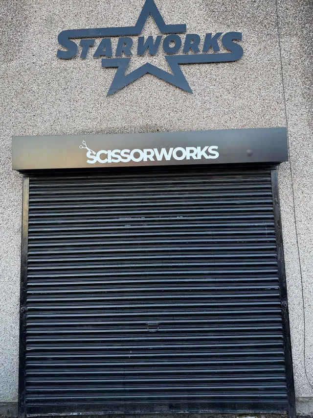 The Scissorworks sign above the shutters